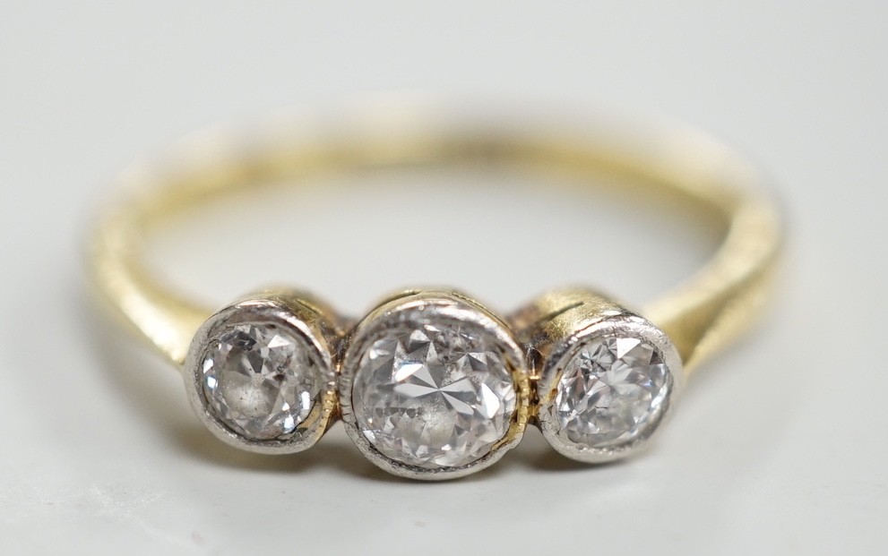 A mid 20th century 18ct, plat and three stone collet set diamond ring, size M, gross weight 2.5 grams.